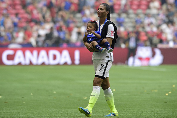 USA midfielder Shannon Box walks on the field with daughter Zoe after winning the final football match between USA and Japan during their 2015 FIFA Women's World Cup at the BC Place Stadium in Vancouver on July 5, 2015.  AFP PHOTO / FRANCK FIFE        (Photo credit should read FRANCK FIFE/AFP/Getty Images)