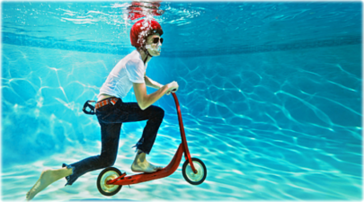 getty_rf_photo_of_boy_riding_scooter_underwater