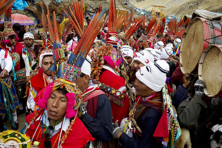 In this May 23, 2016 photo, pilgrims wait for the start of a procession to the Sanctuary of the Lord of the Qoyllur Rit’i, as part of the the syncretic festival of the same name, translated from the Quechua language as Snow Star, in the Sinakara Valley, in Peru's Cusco region. Tens of thousands of pilgrims crowd into the Andean valley, with dancers in multi-layered skirts and musicians with drums and flutes performing non-stop for the three-day festival. (AP Photo/Rodrigo Abd)