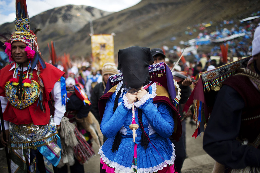 In this May 23, 2016 photo, pilgrims wait for the start of a procession to the Sanctuary of the Lord of the Qoyllur Rit’i, as part of the syncretic festival of the same name, translated from the Quechua language as Snow Star, in the Sinakara Valley, in Peru's Cusco region. Religious processions, dance and music are central to the three-day celebration. (AP Photo/Rodrigo Abd)