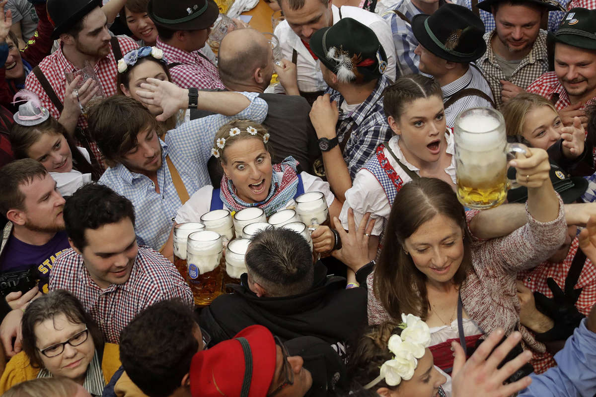 A waitress is surrounded by visitors during the opening ceremony of the 183rd Oktoberfest beer festival in Munich, southern Germany, Saturday, Sept. 17, 2016. The world's largest beer festival will be held from Sept. 17 to Oct. 3, 2016. (AP Photo/Matthias Schrader)