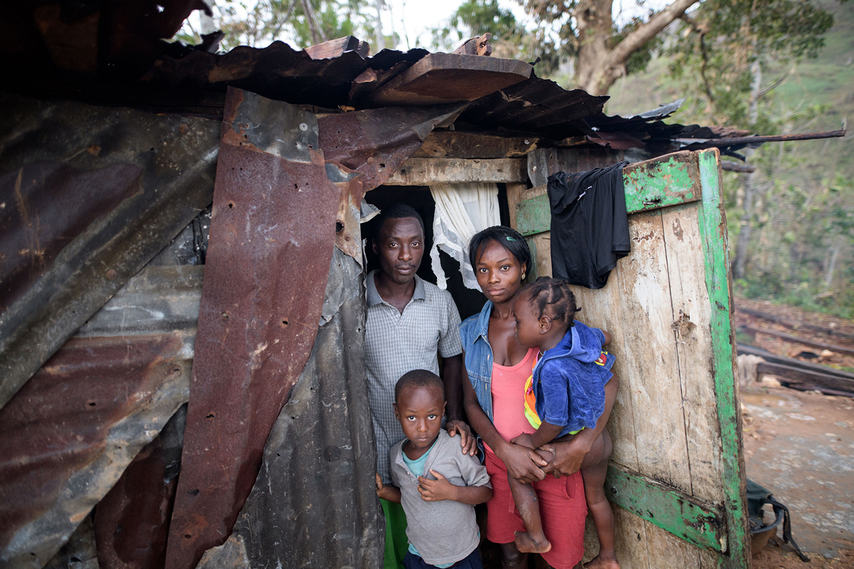 CAMP PERRIN, HAITI - OCTOBER 15: A young family pictured in their provisionally shelter build of old corrugated sheet on October 15, 2016 in Saut-Maturin near Camp Perrin, Haiti. Matthew had heavily devastated the southern half of Haiti on Tuesday last week. According to preliminary information from the authorities, 372 people were killed. Some regions are still cut off from the rest of the country. In some cities 80 per cent of the houses are destroyed or damaged, according to aid organizations. (Photo by Thomas Lohnes/Getty Images)