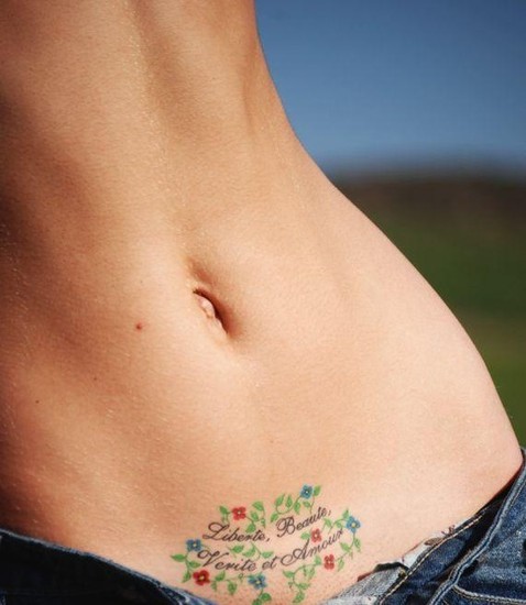 sexy-small-tattoo-with-quote-and-flower-designs-on-upper-pubic